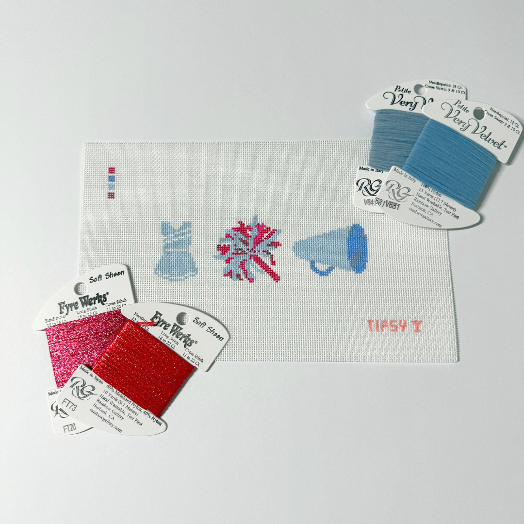 Cheer Needlepoint Kit with Embroidery floss packages with color swatches on a white background