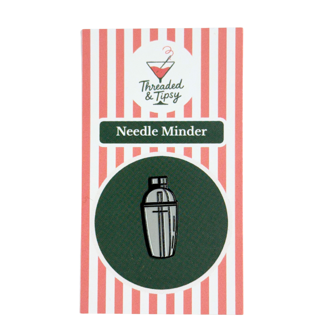 Packaging of a Needle Minder with striped design and brand logo.