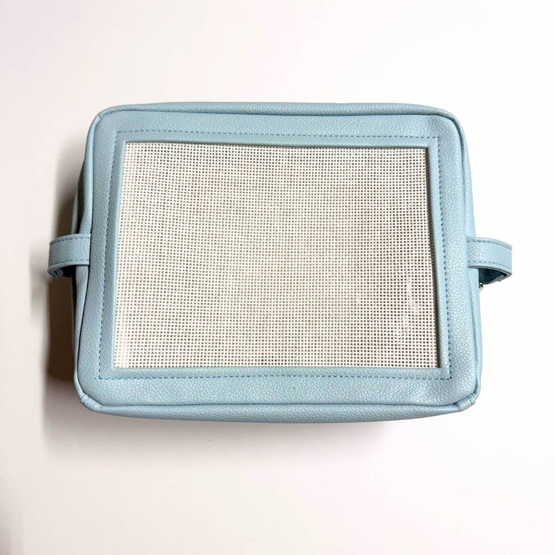 light blue stitchable needlepoint pouch from Threaded & Tipsy