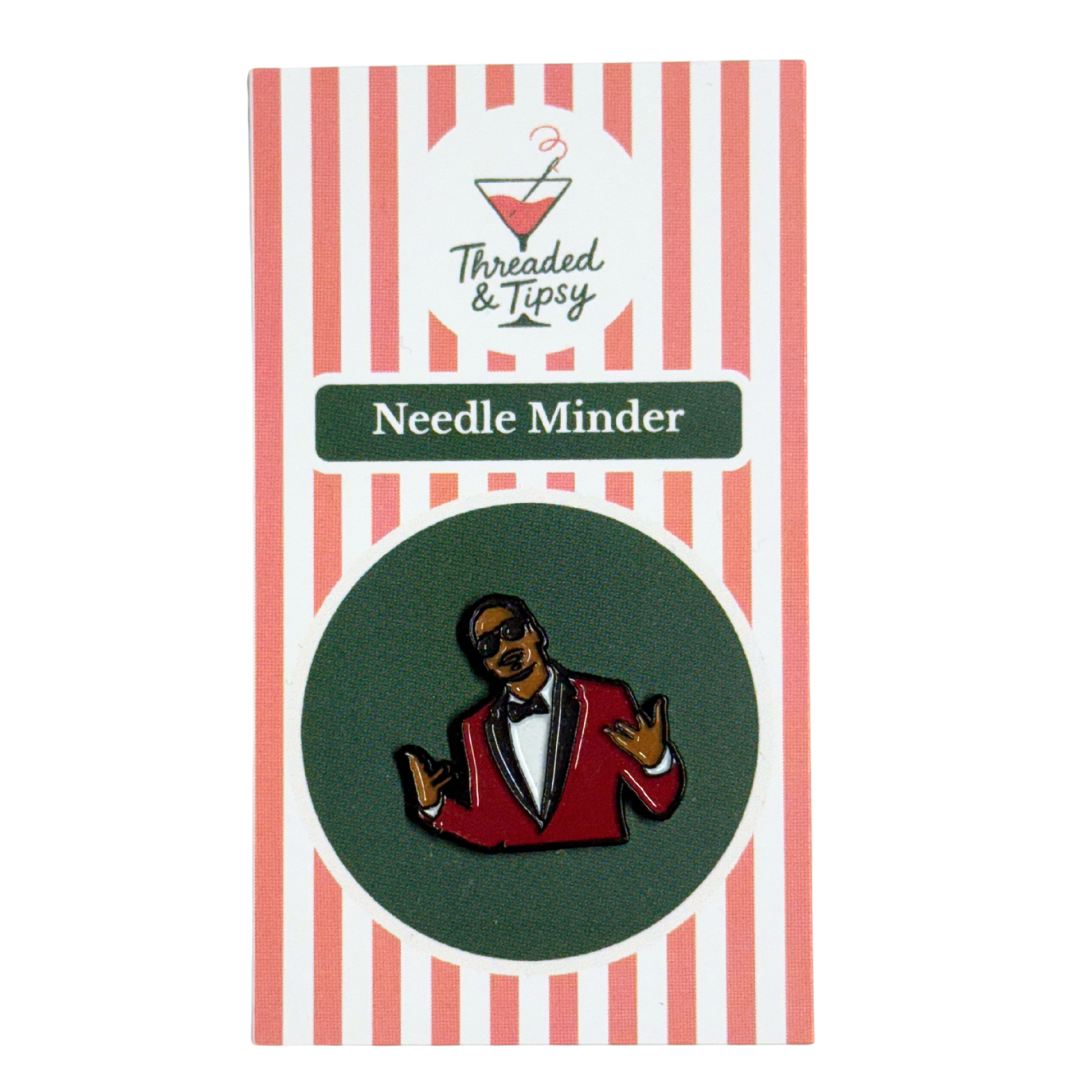Needle Minder with a character design on a striped packaging