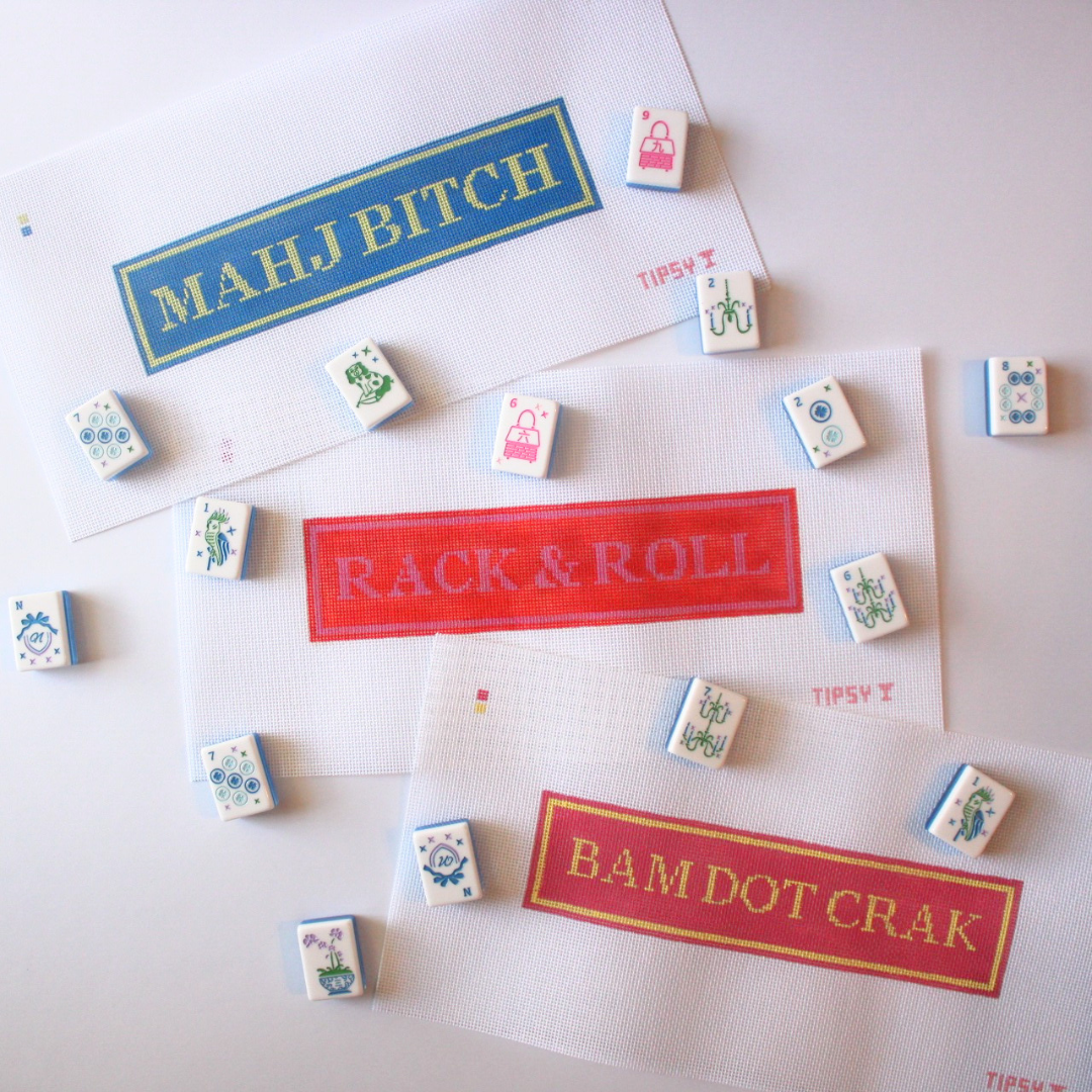 Colorful game pieces with needlepoint canvases featuring humorous text on a white background