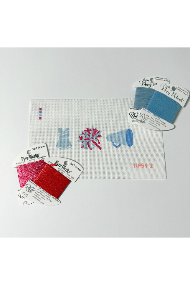 Cheer Needlepoint Kit with Embroidery floss packages with color swatches on a white background