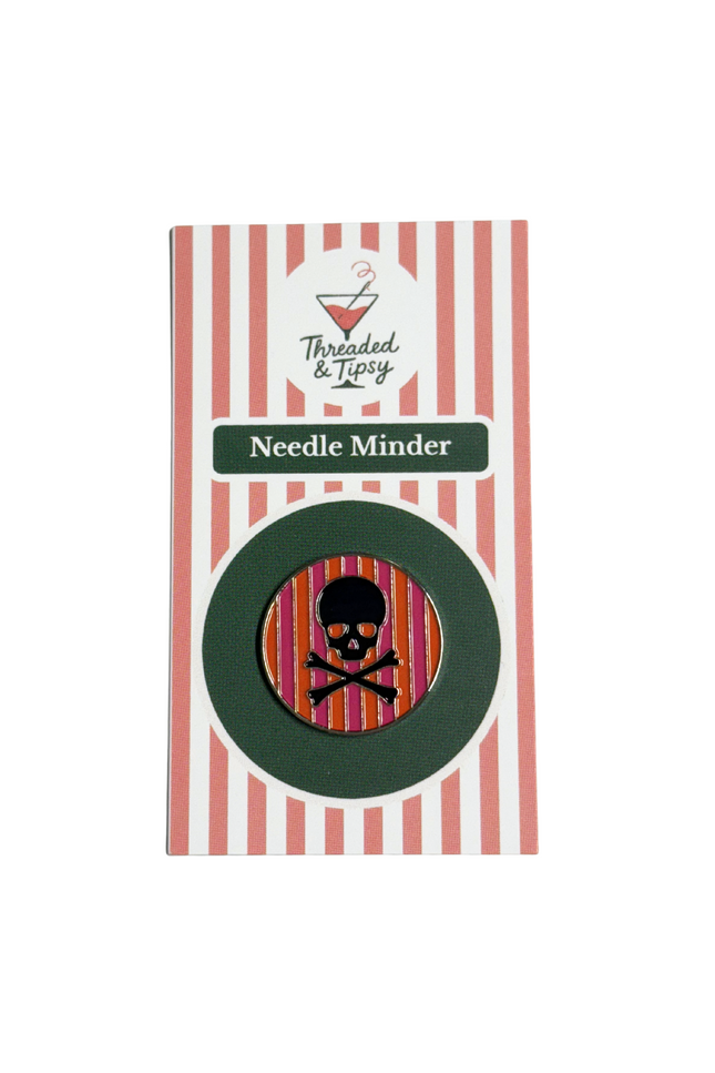 Needle Minder with skull design on striped packaging