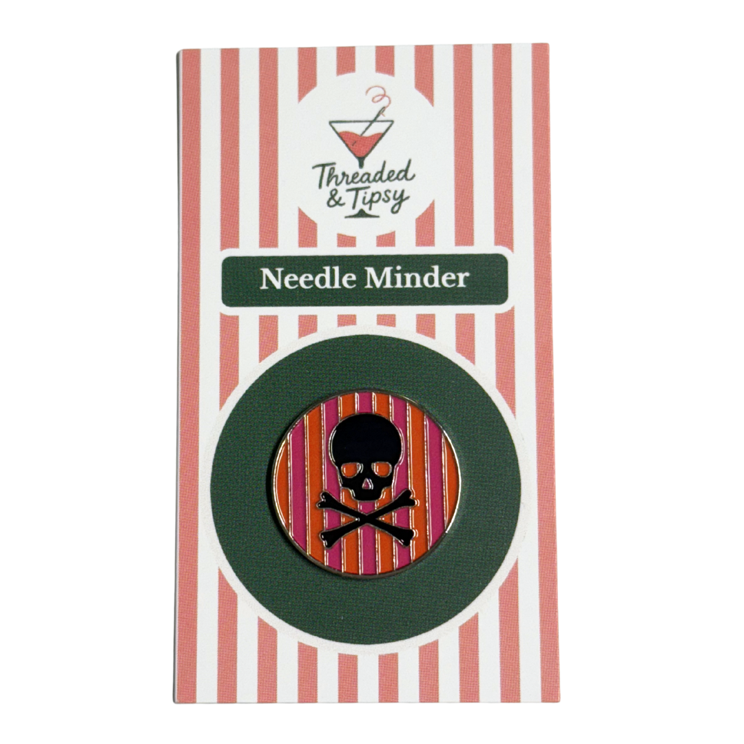 Needle Minder with skull design on striped packaging