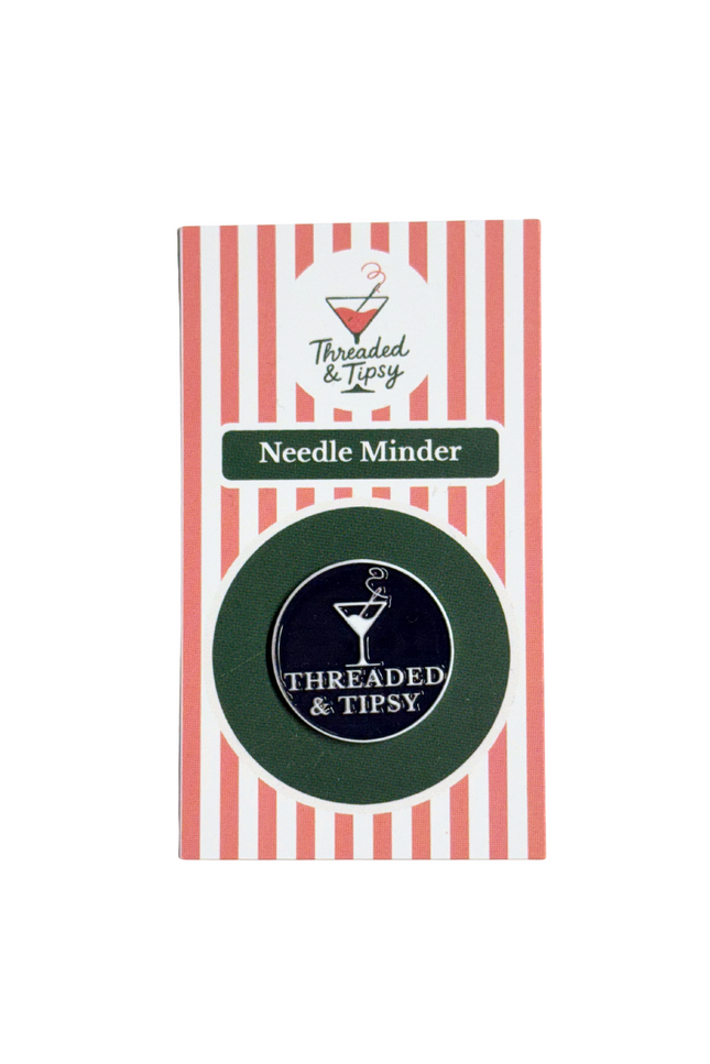 Threaded & Tipsy Needle Minder packaging with red and white striped design