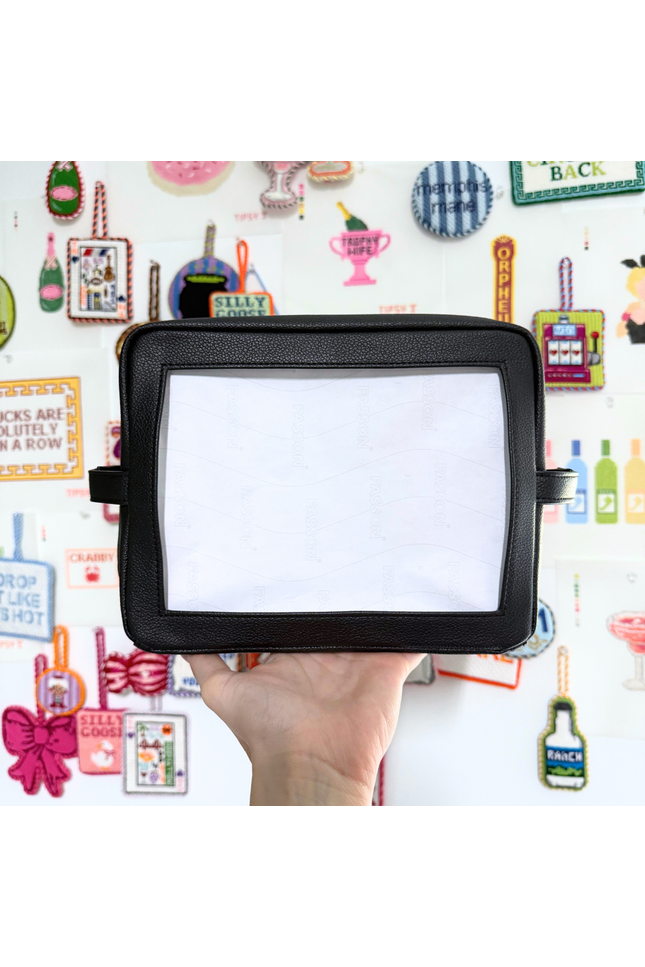 Needlepoint Self-Finishing Black Pouch background with various small objects.