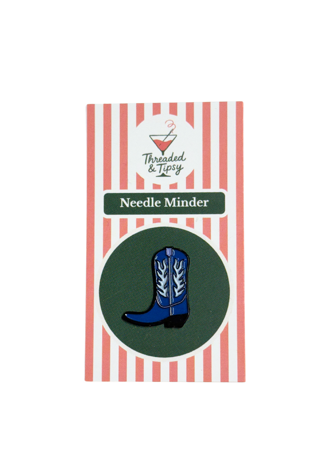 Blue cowboy boot needle minder on striped packaging with 'Threaded & Tipsy' branding