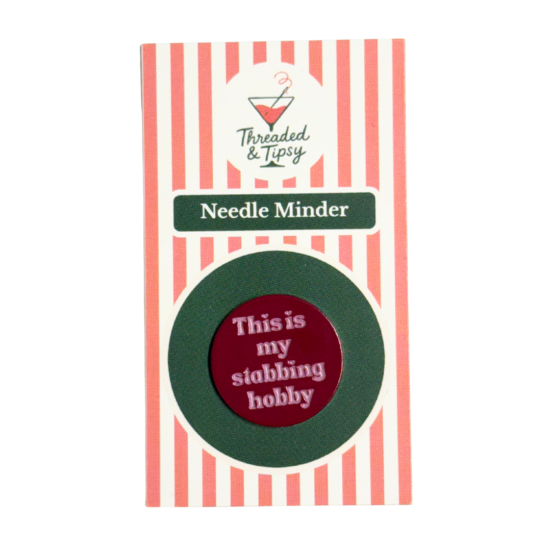 Needle Minder with humorous text on striped packaging that says Threaded and Tipsy