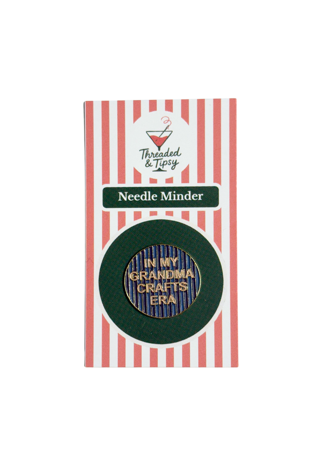Needle minder with 'In my grandma crafts era' text on a striped packaging