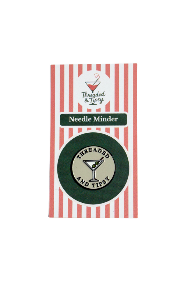 Threaded & Tipsy Needle Minder packaging with red and white striped background