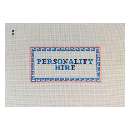 Threaded &amp; Tipsy hand-painted needlepoint canvas featuring the phrase “PERSONALITY HIRE” in bold blue and navy block letters. The text is framed by a pink and blue geometric border. A small painted color guide with three swatches—navy, blue, and peach—is located in the upper left corner. The canvas is unstitched and presented on a plain white background.