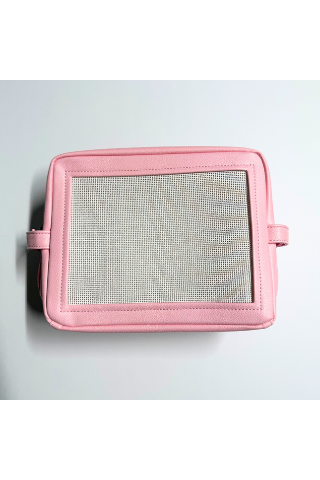 Pink needlepoint stitchable bag with a mesh panel on a light gray background