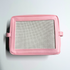 Pink needlepoint stitchable bag with a mesh panel on a light gray background