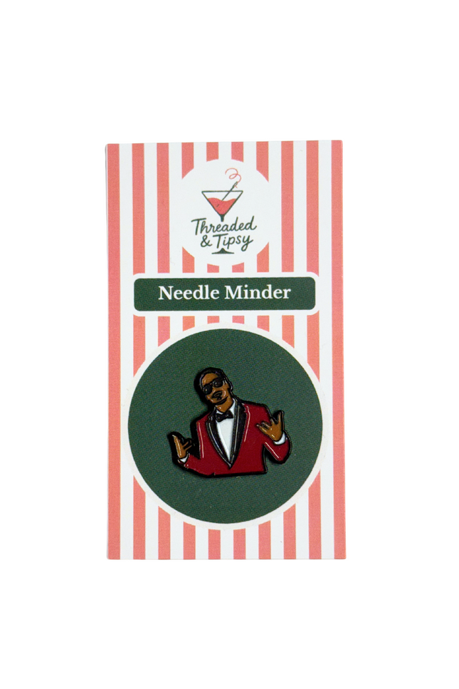 Needle Minder with a character design on a striped packaging
